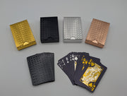 Black waterproof PET plastic playing cards with embossed foil, showing card faces and patterned backs