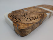 Ivory Crossing Origin Turkish olivewood cribbage board with white resin — close-up of wood, resin and playing tracks.