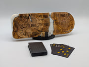 Ivory Crossing Origin Turkish olivewood cribbage board with white resin — shown with included cards, pegs and display stand.