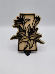 Saskatchewan lily sign in black over maple
