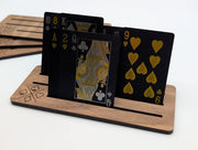 Close-up of a walnut playing card holder with cards standing in the slots; cards sold separately