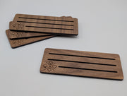 Walnut playing card holders without cards showing the engraved suit motif and three slots